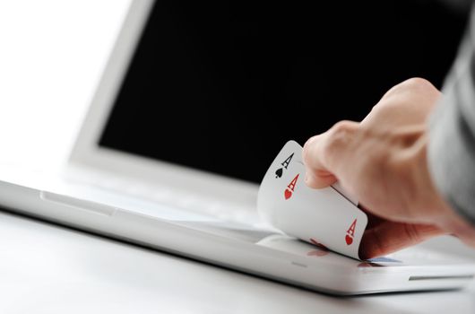 poker online, poker cards on white laptop - gambling concept photo