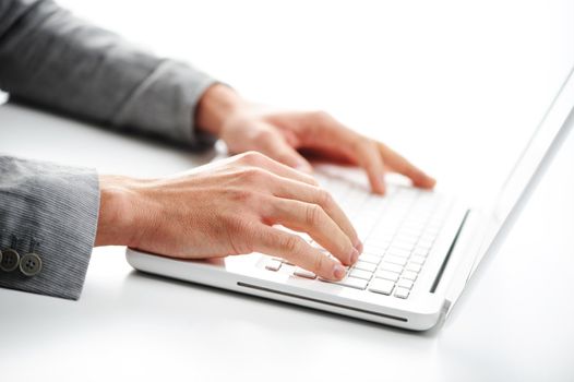 Businessman working at laptop computer, white background