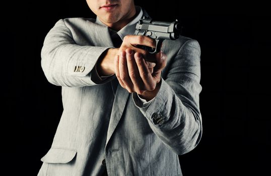 secret-agent guy  holding a gun