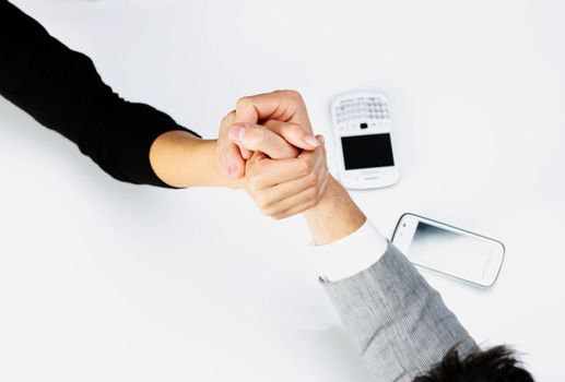 Top view  - businessman and businesswoman arm wrestling on table. 