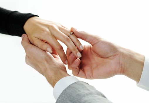 man putting a  ring with a brilliant on a female hand, love concept