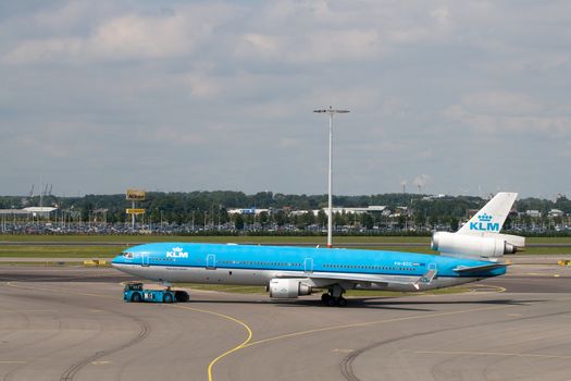 AMSTERDAM - JUNE 16: KLM Royal Dutch Airlines McDonnell Douglas MD-11 at Schiphol airport June 16, 2009 in Amsterdam, Netherlands. MD-11 is a three-engine medium to long range widebody jet airliner. Schiphol is the Netherlands main international airport and is ranking as Europe’s 5th and the world's 15th busiest airport by total passenger traffic.