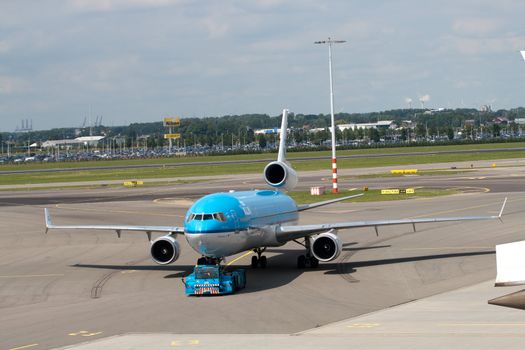 AMSTERDAM - JUNE 16: KLM Royal Dutch Airlines McDonnell Douglas MD-11 at Schiphol airport June 16, 2009 in Amsterdam, Netherlands. MD-11 is a three-engine medium to long range widebody jet airliner. Schiphol is the Netherlands main international airport and is ranking as Europe’s 5th and the world's 15th busiest airport by total passenger traffic.