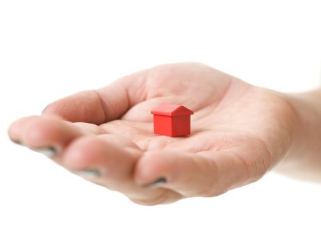 Open hand with Toy house isolated on white background