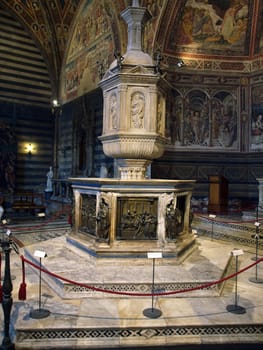 Siena - baptismal font situated in the central place of the Baptistery