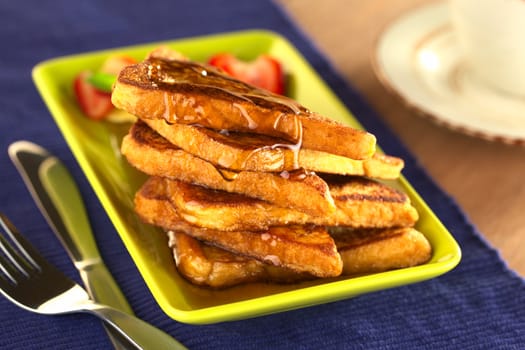 French toast with maple syrup (Selective Focus, Focus on the front of the upper slice) 