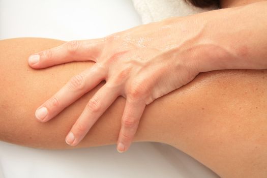 A female masseur giving massage, detail of arm