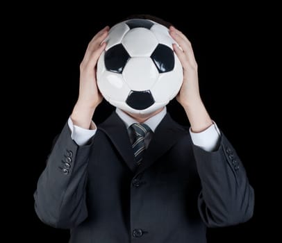 man in suit holding a soccer ball in front of his face