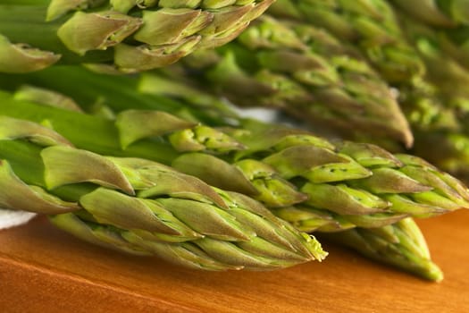 Closeup of raw green asparagus heads (Selective Focus, Focus on the asparagus head in the front)