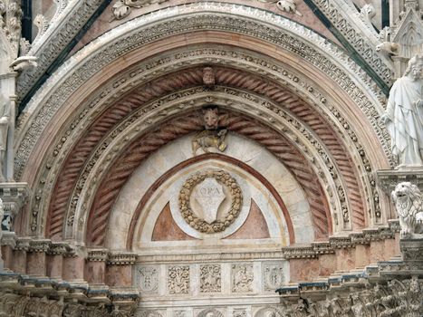 Siena - marble Duomo portal. The Duomo of Siena, which was built in the 12th and 13th centuries, is one of the prettiest churches in Gothic style in Italy