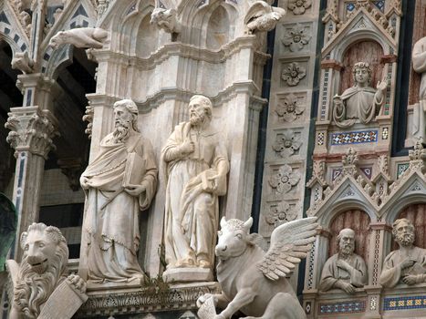 Architectural details of Duomo facade - Siena,Tuscany,Italy. The Duomo of Siena, which was built in the 12th and 13th centuries, is one of the prettiest churches in Gothic style in Italy
