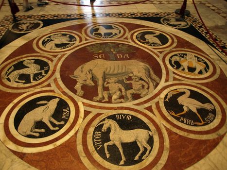 Siena - Duomo interior. One of the 56 magnificent etched and inlaid marble floor panels. The Sienese She Wolf with emblems of 12 confederate cities