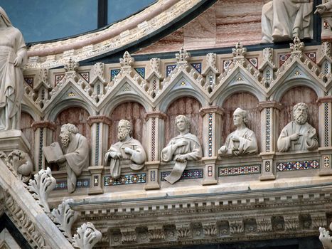 Architectural details of Duomo facade - Siena,Tuscany,Italy. The Duomo of Siena, which was built in the 12th and 13th centuries, is one of the prettiest churches in Gothic style in Italy