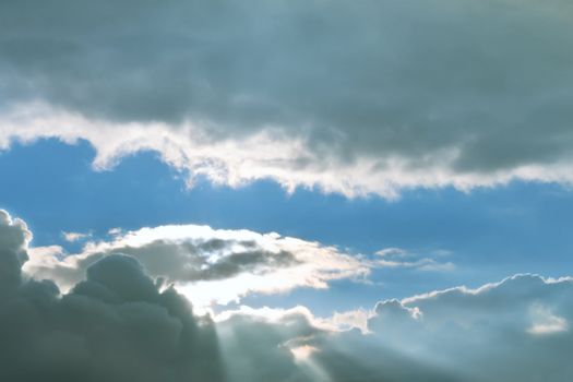 Window in the sky. Sun beams punched through the clouds