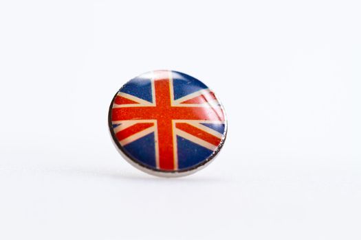 U.K flag symbol deorated on thumbtack on white sutface