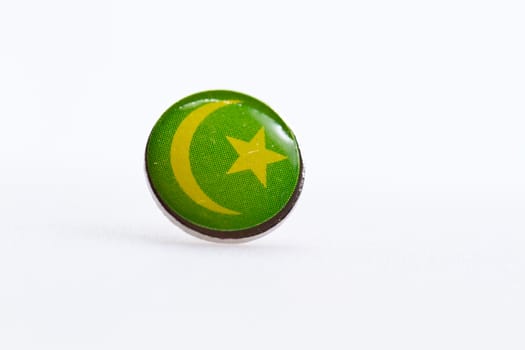 Mauritania flag symbol on thumbtakc on white surface