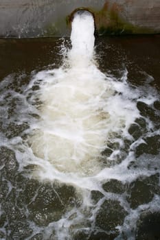 water pollution , running water from pipe into river