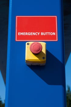 red emergency button on blue culomn