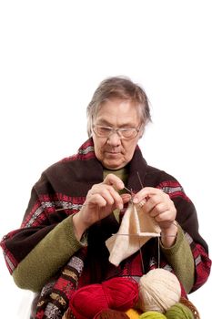 old woman sitting in a chair and knit