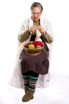 old woman sitting in a chair and knit