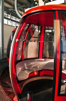 Alpine opened red cable car  in station