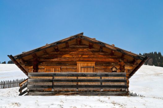 Old winter wood cottage in Dolomiti Alps, Ortisei, italy.