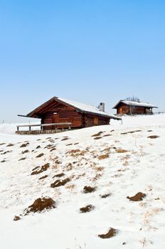 Old winter wood cottages in Dolomiti Alps, Ortisei, italy.