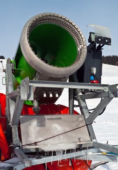 green artificial snow cannon on mountains
