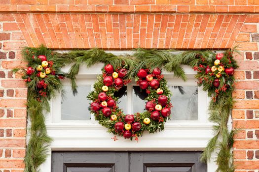 Traditional design of a christmas wreath attached to the front of old house
