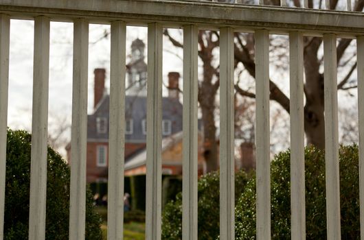 WILLIAMSBURG, VIRGINIA - DECEMBER 30: Governors Palace decorated for xmas seen through railings on December 30, 2011. Colonial Williamsburg's 301 acres includes many restored buildings and houses