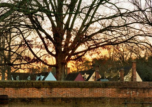 WILLIAMSBURG, VIRGINIA - DECEMBER 30: Sun rises over the restored houses on December 30, 2011. Colonial Williamsburg's 301 acres includes many restored buildings and houses