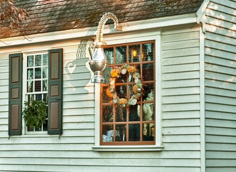 WILLIAMSBURG, VIRGINIA - DECEMBER 30: Sun rises on old shop on December 30, 2011. Colonial Williamsburg's 301 acres includes many restored buildings and houses