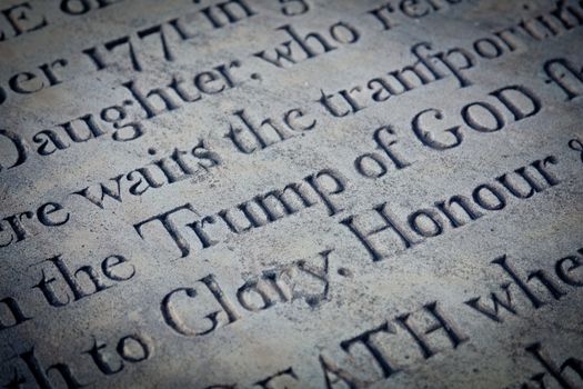 Potential humorous carving focused on Trump of god in churchyard gravestone