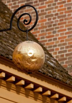 Golden sphere in front of old Jewellery shop