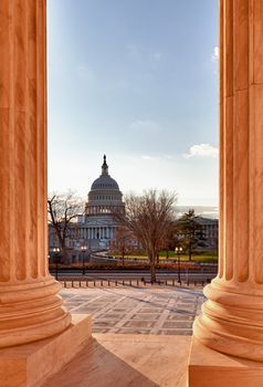 Late afternoon winter sun illuminates front of supreme court in Washington in winter with view of Capitol