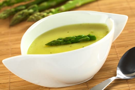 Cream of green asparagus (Selective Focus, Focus on the asparagus head on the soup)