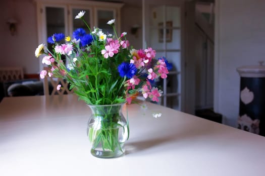 Beautiful spring summer flowers in a glass vase in a living room digital art manipulation