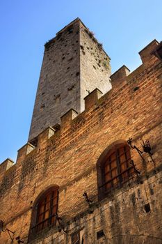 Medieval Stone Tower Town Hall San Gimignano Tuscany Italy Pink Flowers Windows Walls