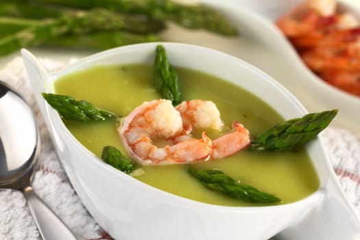 Cream of green asparagus with shrimp (Selective Focus, Focus on the lower edge of the shrimp)