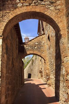 Ancient Stone Arches Street Flowers Medieval Town San Gimignano Tuscany Italy