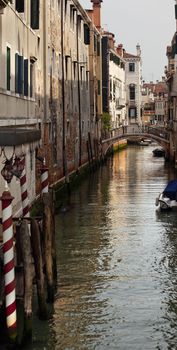 Small Canal Poles Bridge Buildings Boats Reflections Venice Italy