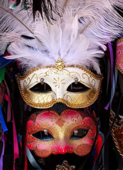 White Red Venetian Masks White Feathers Ribbons Venice Italy Used since the 1200s for Carnival, which were celebrated just before Lent.  In ancient times, Masks allowed the Venetians to do what was illegal, such as gambling.