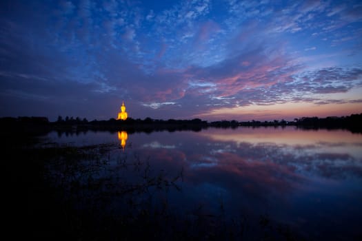 Golden Big buddha statue and lake at sunset in thailand