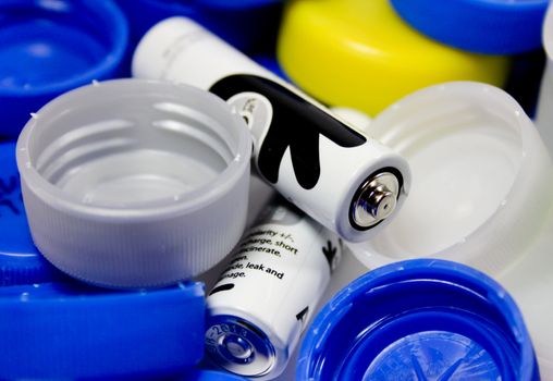 Alkaline battery with bottle caps