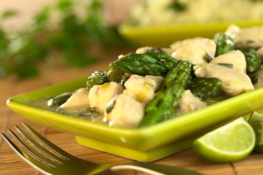 Green asparagus and chicken fricassee (Selective Focus, Focus on the asparagus tip in the middle of the image)