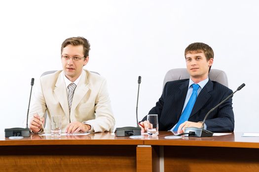 two businessmen sitting in a chair at the table, talk at the conference