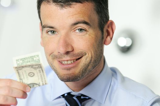 winner and cheerful businessman is showing a dollar