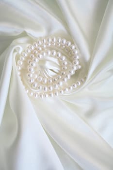 Smooth elegant white silk with pearls can use as wedding background 