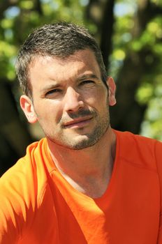natural looking young man with orange clothed