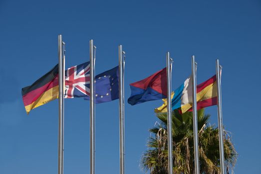 The Flags of Germany,United Kingdom,European Union,Lanzarote,Canary Islands and Spain under a blue sky